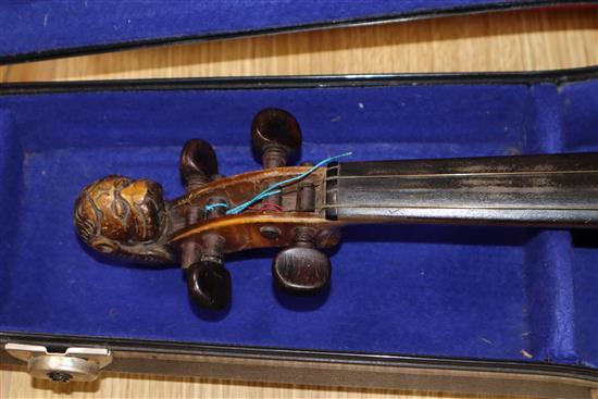 A German 19th century violin with two-piece back, faux Guadagnini label and carved lions head terminal, cased